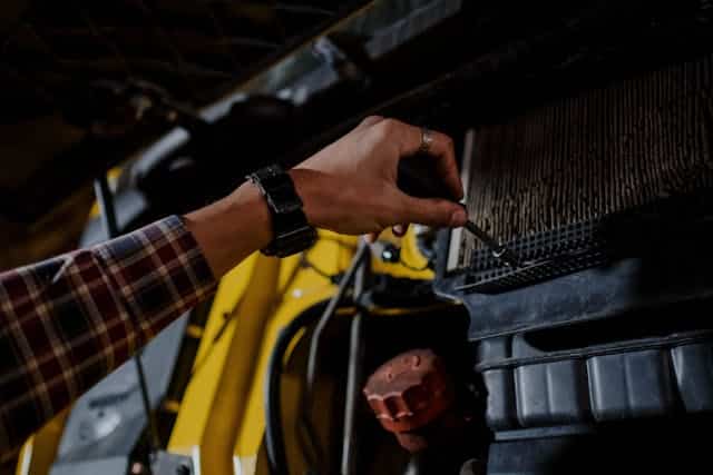 Person adding air to truck filter